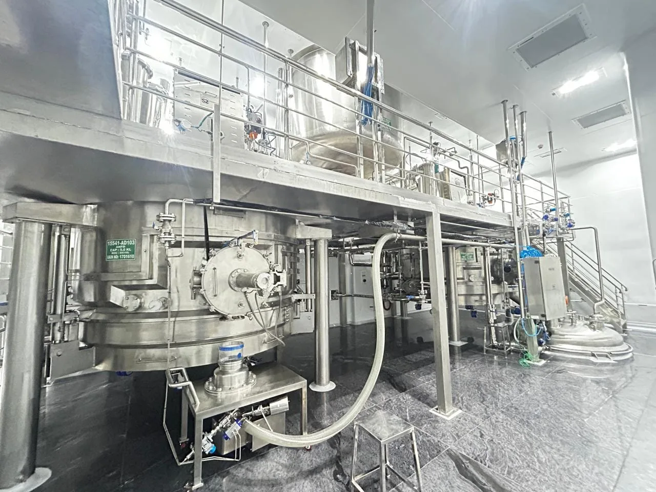 Stainless steel reactor and dryer train on a mezzanine in an API plant