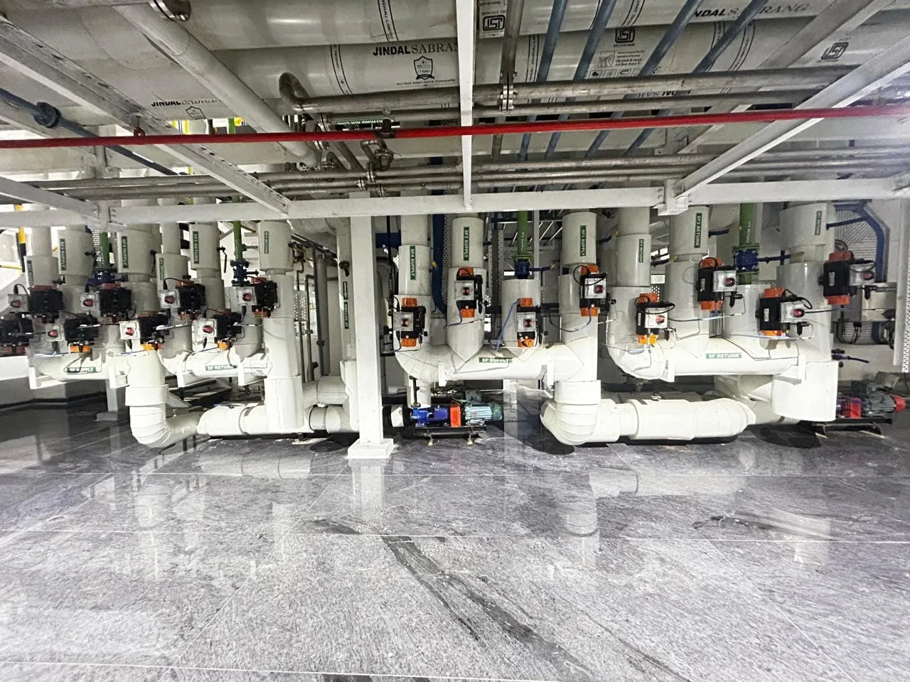 Pneumatic valve and pump station beneath the utility pipe rack of an API block